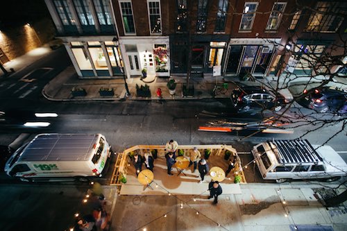 People gathered outside of Lokal Hotel Old City Opening shot from above on the street