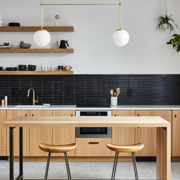 Efficiency apartment style kitchen in lokal hotel fishtown with sleek scandinavian color scheme of white, black and white oak and black steel